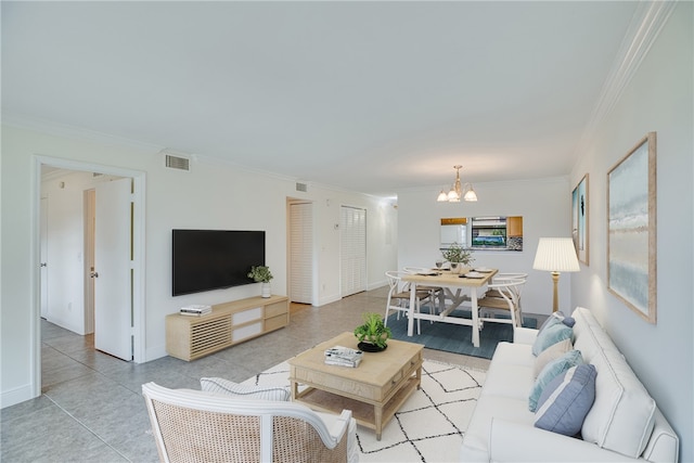 living room with an inviting chandelier and crown molding