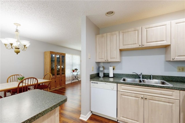 kitchen featuring dark wood-type flooring, sink, a chandelier, hanging light fixtures, and white dishwasher