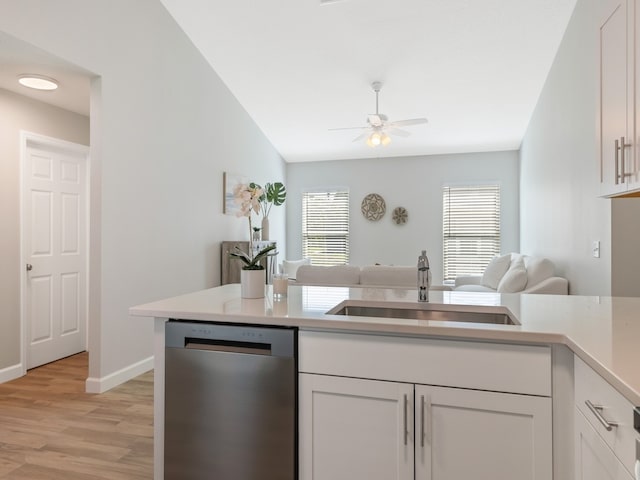 kitchen with white cabinets, sink, light hardwood / wood-style flooring, and dishwasher