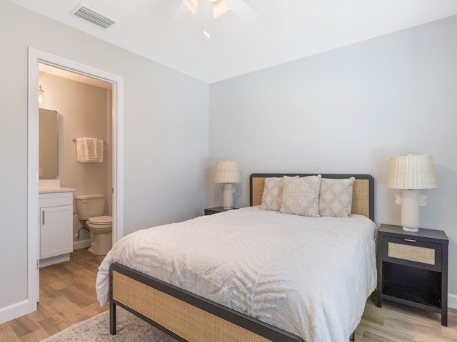 bedroom with light hardwood / wood-style floors, ceiling fan, and ensuite bathroom