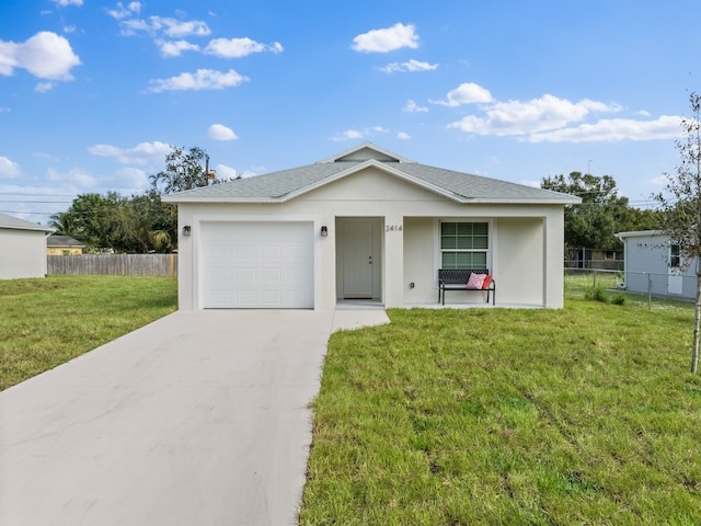 view of front of home featuring a garage and a front yard