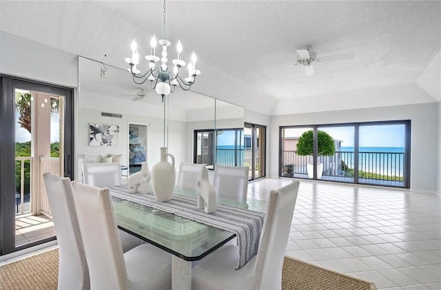 8830 S Sea Oaks Way Unit 301, Vero Beach, FL 32963 - dining space featuring a ceiling fan, a textured ceiling, healthy amount of natural light, a chandelier, and light tile patterned floors