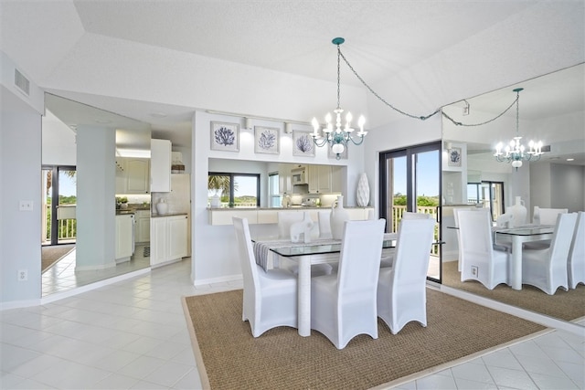 8830 S Sea Oaks Way Unit 301, Vero Beach, FL 32963 - dining space with a chandelier and light tile patterned floors