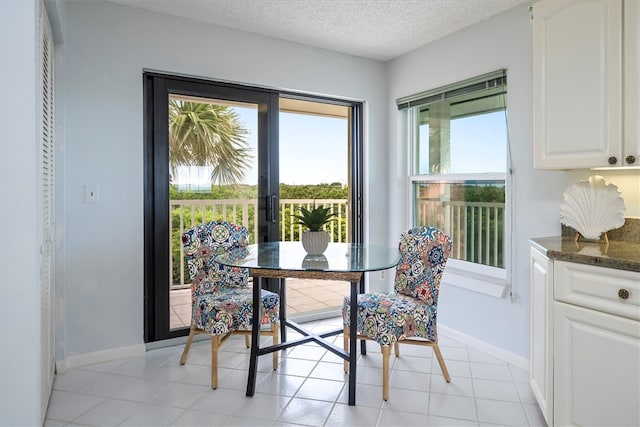 8830 S Sea Oaks Way Unit 301, Vero Beach, FL 32963 - dining space featuring a textured ceiling and french doors