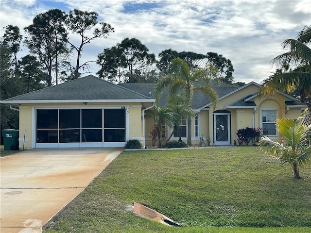 view of front of house with a garage and a front yard