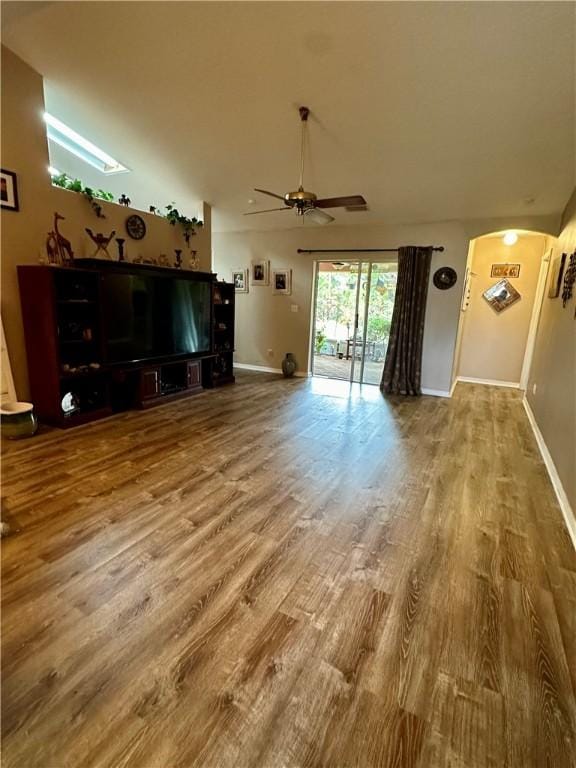 unfurnished living room with wood-type flooring and ceiling fan