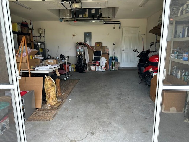 garage with electric water heater and electric panel