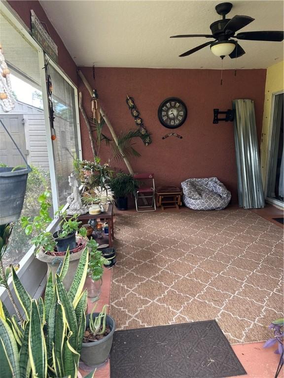 sunroom / solarium with ceiling fan