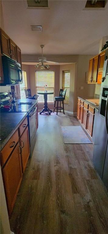 bathroom with a tub, hardwood / wood-style floors, vanity, and a textured ceiling