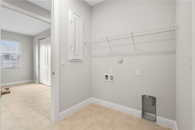 laundry area with hookup for a gas dryer, light tile patterned floors, and hookup for a washing machine