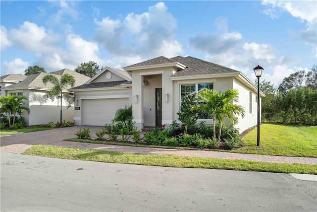 view of front of house with a garage and a front lawn