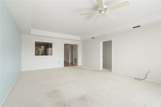 5540 N Harbor Village Dr Unit 103, Vero Beach, FL 32967 - carpeted spare room with visible vents, ceiling fan, and a tray ceiling