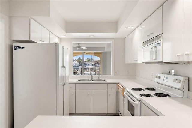 5540 N Harbor Village Dr Unit 103, Vero Beach, FL 32967 - kitchen with light countertops, white appliances, white cabinetry, and a sink