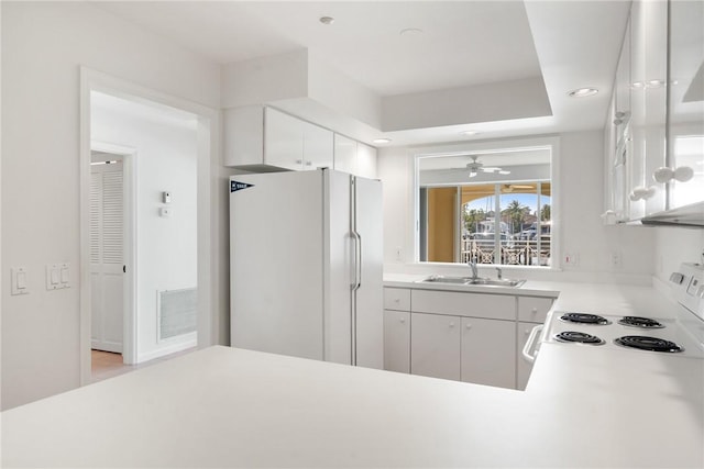 5540 N Harbor Village Dr Unit 103, Vero Beach, FL 32967 - kitchen featuring white appliances, a ceiling fan, visible vents, light countertops, and a sink
