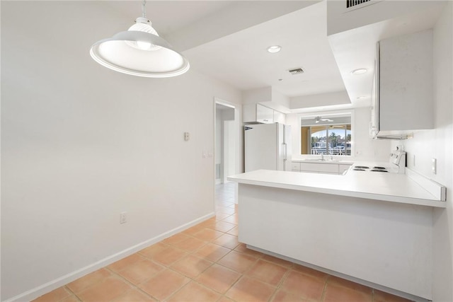 5540 N Harbor Village Dr Unit 103, Vero Beach, FL 32967 - kitchen with freestanding refrigerator, electric range, a peninsula, light countertops, and baseboards