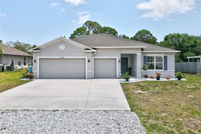 9036 103rd Ave, Vero Beach, FL 32967 - view of front of house with concrete driveway, a garage, stucco siding, and a shingled roof