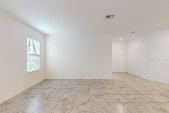 9036 103rd Ave, Vero Beach, FL 32967 - empty room featuring light tile patterned floors and recessed lighting