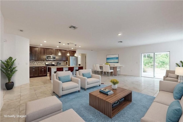9036 103rd Ave, Vero Beach, FL 32967 - living room with light tile patterned floors and recessed lighting