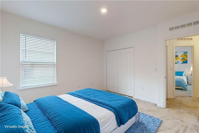 9036 103rd Ave, Vero Beach, FL 32967 - bedroom featuring light colored carpet, a closet, and recessed lighting