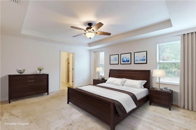 9036 103rd Ave, Vero Beach, FL 32967 - bedroom featuring a tray ceiling and a ceiling fan