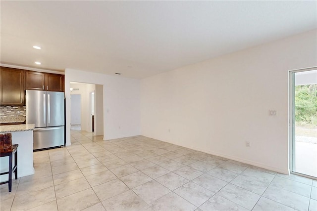 9036 103rd Ave, Vero Beach, FL 32967 - unfurnished living room featuring recessed lighting and light tile patterned floors
