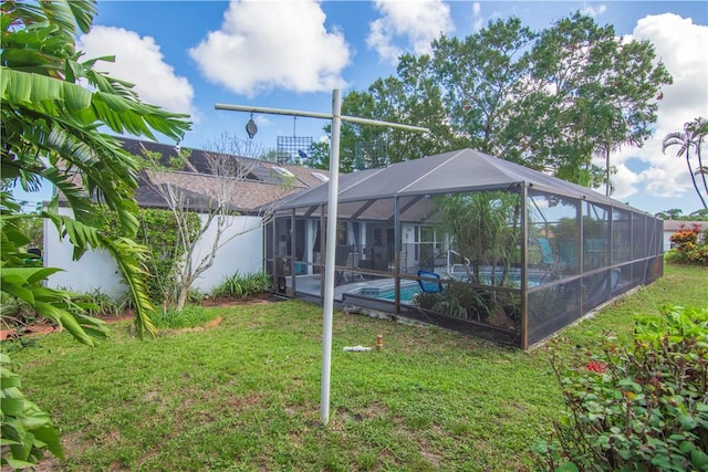 742 Whitmore Dr, Port St Lucie, FL 34984 - back of property with an outdoor pool, a yard, and glass enclosure
