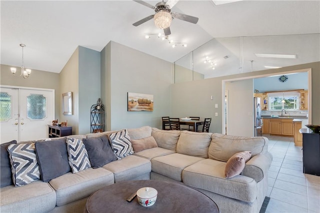 742 Whitmore Dr, Port St Lucie, FL 34984 - living area featuring a ceiling fan, light tile patterned floors, a chandelier, french doors, and high vaulted ceiling