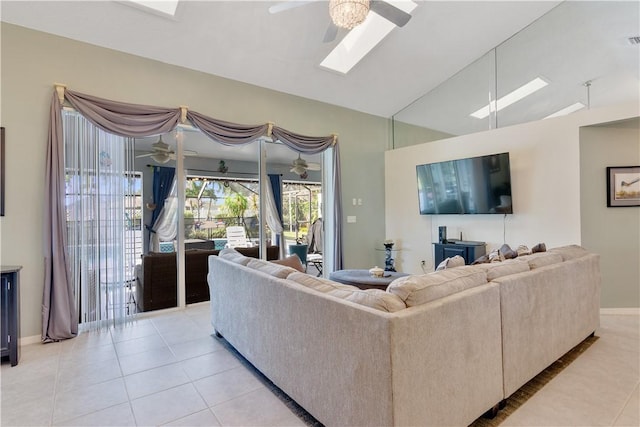742 Whitmore Dr, Port St Lucie, FL 34984 - living area featuring a ceiling fan, a skylight, vaulted ceiling, and light tile patterned floors