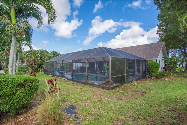 742 Whitmore Dr, Port St Lucie, FL 34984 - back of property with an outdoor pool, a lawn, and glass enclosure
