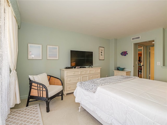 bedroom featuring light carpet