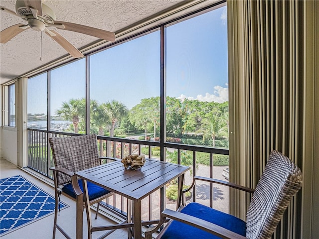 unfurnished sunroom with a wealth of natural light and ceiling fan