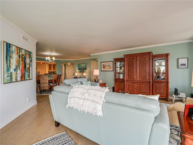 living room with light hardwood / wood-style floors, a notable chandelier, and crown molding