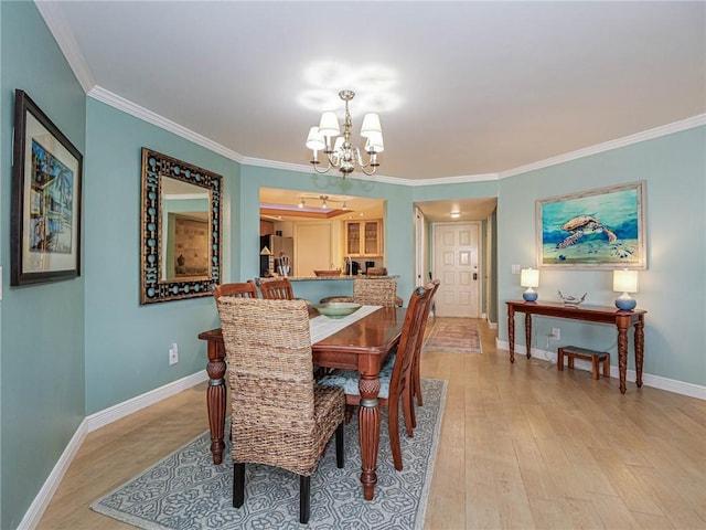 1850 Bay Rd Unit 3G, Vero Beach, FL 32963 - dining room with a chandelier, light wood-style flooring, and ornamental molding