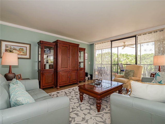 living room featuring ornamental molding, light wood-type flooring, and ceiling fan