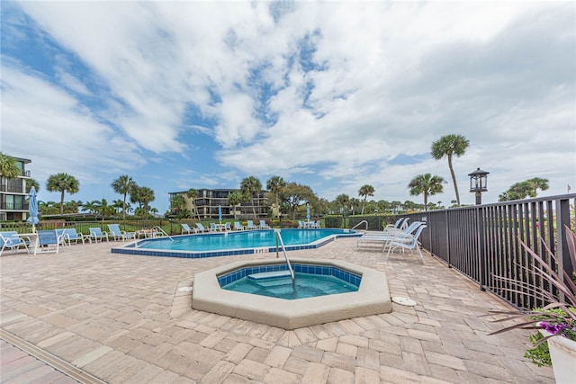 view of pool with a community hot tub and a patio