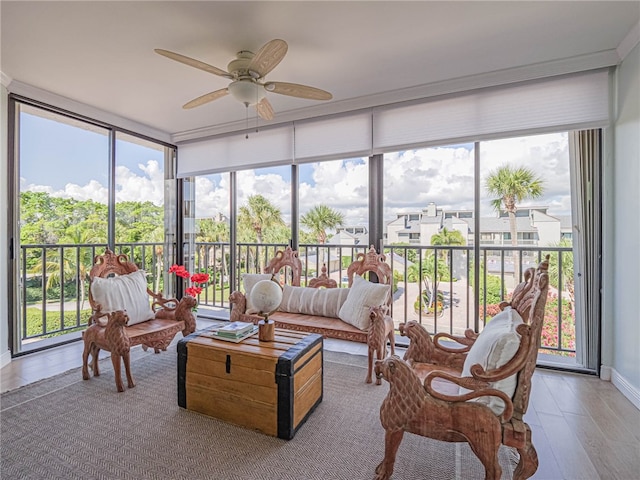 sunroom featuring a healthy amount of sunlight and ceiling fan