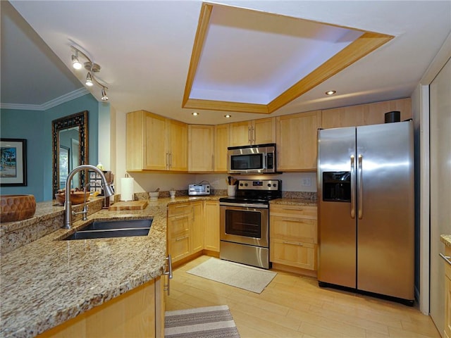 1850 Bay Rd Unit 3G, Vero Beach, FL 32963 - kitchen featuring stainless steel appliances, light brown cabinetry, light stone counters, a raised ceiling, and light wood finished floors
