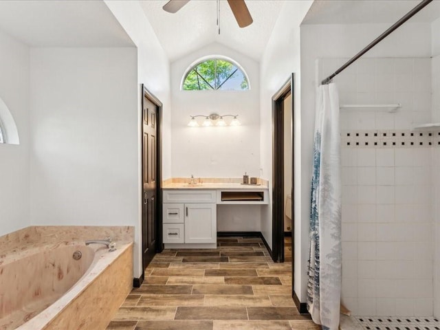 bathroom featuring lofted ceiling, a tile shower, a ceiling fan, a garden tub, and vanity