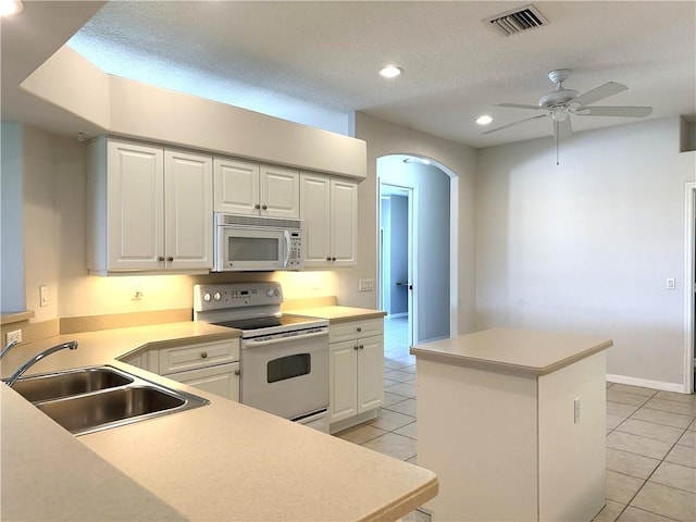 413 W Tangerine Sq SW, Vero Beach, FL 32968 - kitchen with light tile patterned flooring, a sink, white appliances, a center island, and visible vents