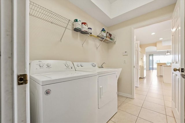413 W Tangerine Sq SW, Vero Beach, FL 32968 - laundry room with independent washer and dryer, light tile patterned flooring, and arched walkways