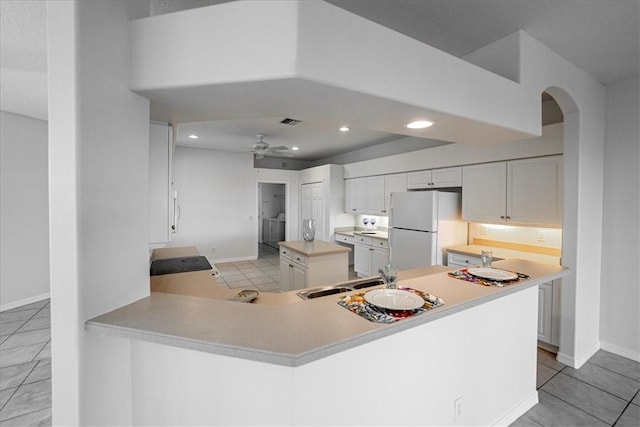 413 W Tangerine Sq SW, Vero Beach, FL 32968 - kitchen featuring white appliances, white cabinets, light countertops, and recessed lighting