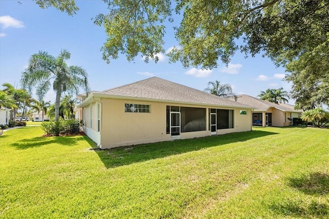 413 W Tangerine Sq SW, Vero Beach, FL 32968 - rear view of house featuring a lawn, stucco siding, and a sunroom