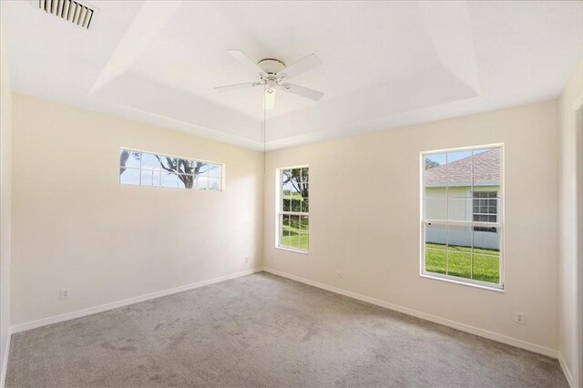 413 W Tangerine Sq SW, Vero Beach, FL 32968 - empty room featuring a raised ceiling, carpet flooring, and ceiling fan