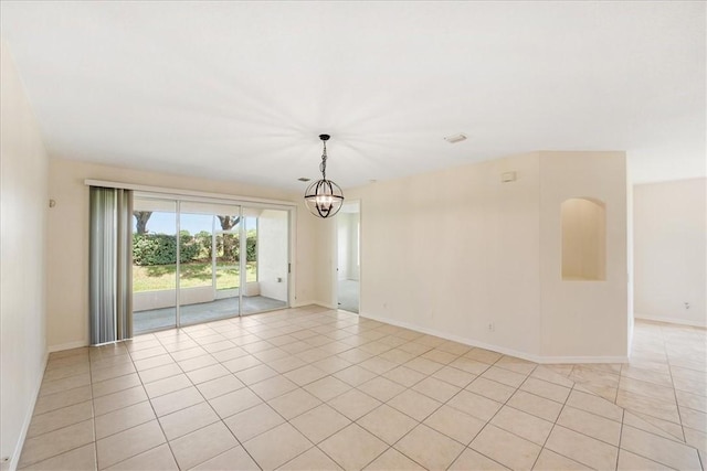 413 W Tangerine Sq SW, Vero Beach, FL 32968 - unfurnished room with a chandelier and light tile patterned flooring