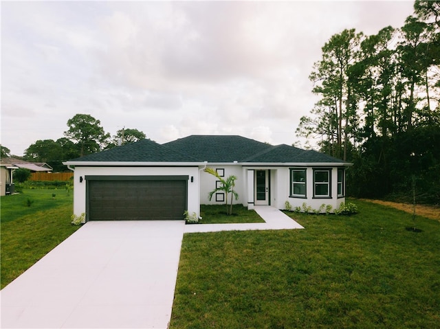 view of front of property featuring a front lawn and a garage