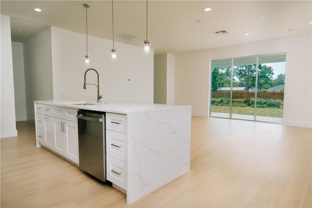 kitchen featuring a sink, light wood-type flooring, stainless steel dishwasher, and white cabinets