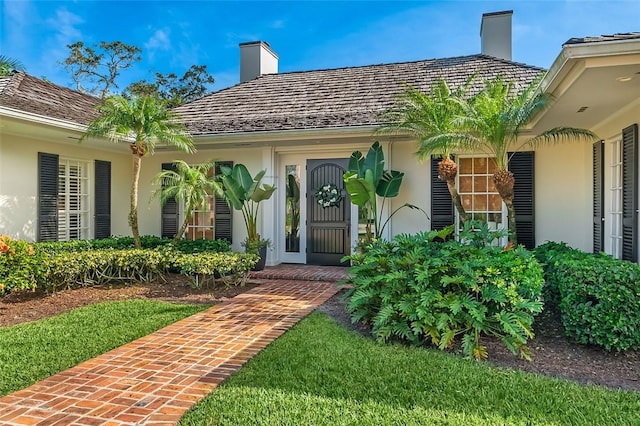 doorway to property with a yard