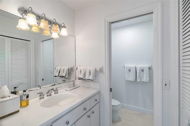 bathroom featuring vanity and toilet