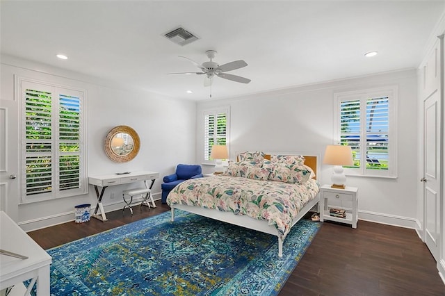 bedroom featuring ceiling fan, dark hardwood / wood-style floors, and multiple windows