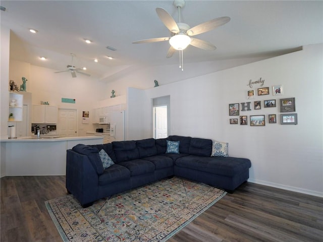 living room featuring ceiling fan, lofted ceiling, sink, and dark hardwood / wood-style flooring